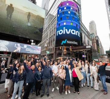 Roivant employees in front of Nasdaq marquee